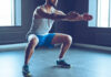 Man performing a squat exercise in a gym