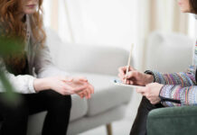 Shocking AI Therapy Risks Revealed by Brown Study Two individuals engaged in a counseling session, one taking notes