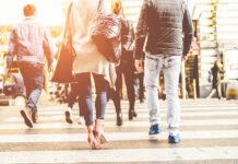 Group of pedestrians crossing a street in an urban setting