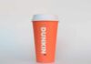 Orange coffee cup with Dunkin' logo