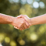 Two hands shaking in a gesture of agreement