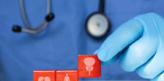 A doctor's gloved hand placing red blocks with health symbols on a table