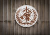 World Health Organization emblem featuring a globe and caduceus