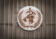 World Health Organization emblem featuring a globe and caduceus