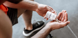 Person pouring probiotic pills into their hand