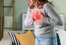 Woman holding her chest in discomfort with a heart illustration