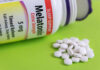 Therapy Breakthrough Tops Drugs in Sleep Battle Bottle of melatonin tablets with some pills spilled on a green surface