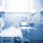 Blurred image of a medical professional in a hospital setting