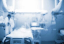 Blurred image of a medical professional in a hospital setting
