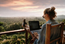 Nature Stress Myth: What Really Works Person working on a laptop outdoors with a scenic sunset view