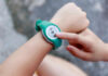 Harvard Study Blows Up Fitness Routine Myths Person using a fitness tracker on their wrist