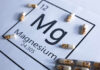 Magnesium Deficiency Risks Exposed Magnesium element symbol with colorful capsules arranged around it