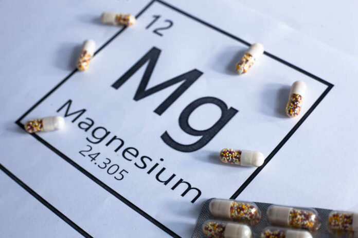 Mg,Magnesium,Pills,Or,Capsules,On,A,White,Background,With Magnesium element symbol with colorful capsules arranged around it