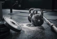 Gym Toughness: Is It Hurting More Or Helping? Kettlebells and weights on a gym floor with chalk dust