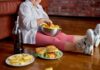 Child sitting on the floor enjoying snacks from a bowl