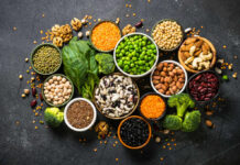 Walnuts: Not The Miracle Cure You Think! An assortment of legumes, nuts, and fresh vegetables arranged in bowls on a dark surface