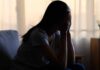 Psychedelic Therapy: The Next Big Thing? A silhouette of a person sitting with their head in their hands, conveying distress