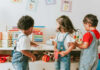 Swimming Pool Tragedy Sparks Daycare Debate Three children engaged in play with educational toys in a colorful classroom
