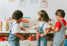 Swimming Pool Tragedy Sparks Daycare Debate Three children engaged in play with educational toys in a colorful classroom
