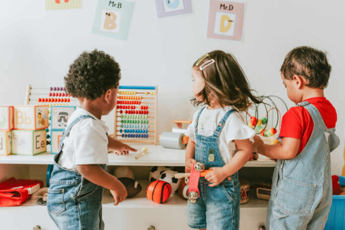 shutterstock1240622437jpg-1 Three children engaged in play with educational toys in a colorful classroom
