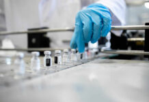 Researchers develop lab compound that slows Alzheimer’s A healthcare professional in a lab preparing vaccine vials