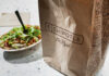 Salad Trap that pushes you Towards the Junk Food A Chipotle takeout bag next to a bowl filled with fresh salad ingredients