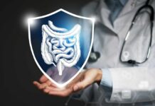 Leaky Gut Flips Aging Playbook A doctor holding a digital shield with a graphic of the digestive system