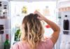 Person looking into an open refrigerator
