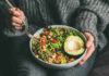 Dinner Trick Slows Brain Decay A person holding a bowl of colorful salad with avocado and greens