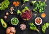 The Four Foods Secretly Making You Smell Bad Raw liver with assorted healthy foods on dark surface