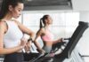 Why You Need Zone 2 Cardio Training in Your Workout Plan Woman on treadmill checking smartwatch in gym