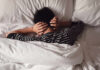 Sleep’s First Hours Decide Everything Child lying in bed with hands over ears