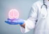 Parkinson’s Entry Point Stuns Researchers A medical professional holding a glowing digital brain illustration in their hand