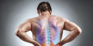 Man holding lower back with highlighted spine illustration