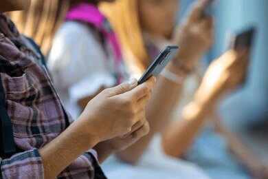1781526598421-p9u768-2682720135 Hands of young people using smartphones