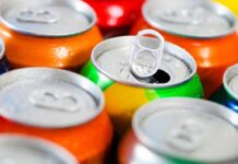 Assorted soda cans with one open pull-tab