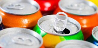 Assorted soda cans with one open pull-tab
