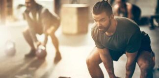 Man lifting a kettlebell in a gym