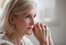 Woman with short blonde hair in thoughtful pose