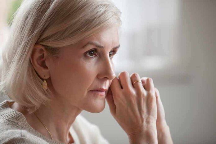 Woman with short blonde hair in thoughtful pose