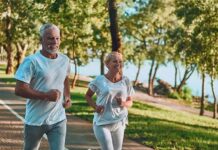 Older couple jogging on a lakeside path