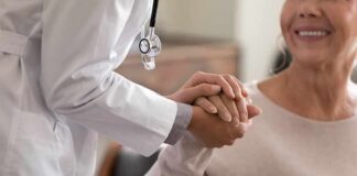 Doctor holding patient’s hand in support