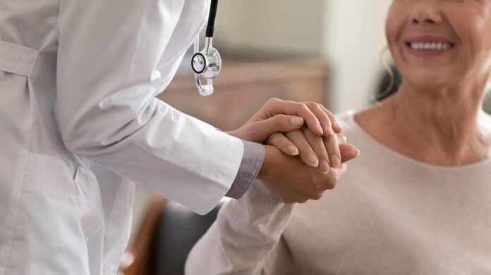 Doctor holding patient’s hand in support