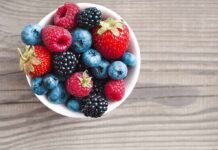 Bowl of mixed berries on wooden table