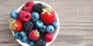 Bowl of mixed berries on wooden table