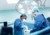 surgeons performing an operation under bright surgical lights