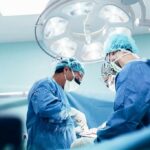 surgeons performing an operation under bright surgical lights