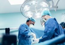 surgeons performing an operation under bright surgical lights