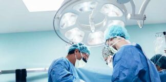 surgeons performing an operation under bright surgical lights