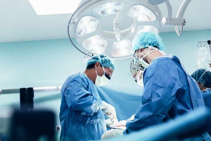 surgeons performing an operation under bright surgical lights